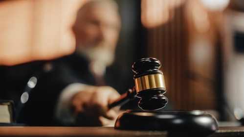 Court of Law and Justice Trial Session: Imparcial Honorable Judge Pronouncing Sentence, striking Gavel. Focus on Mallet, Hammer. Cinematic Shot of Dramatic Not Guilty Verdict. Close-up Shot.